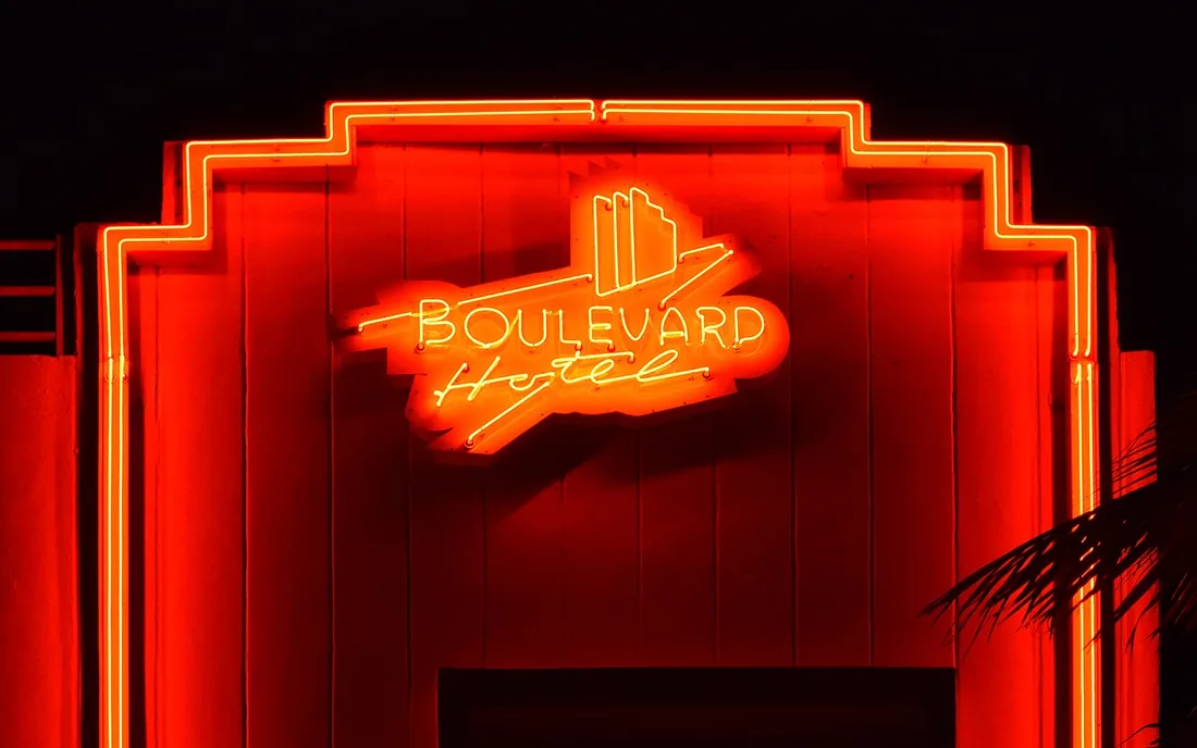 A lit art deco neon sign on Ocean Drive